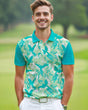 Man wearing a green and blue tropical print golf polo shirt on a golf course