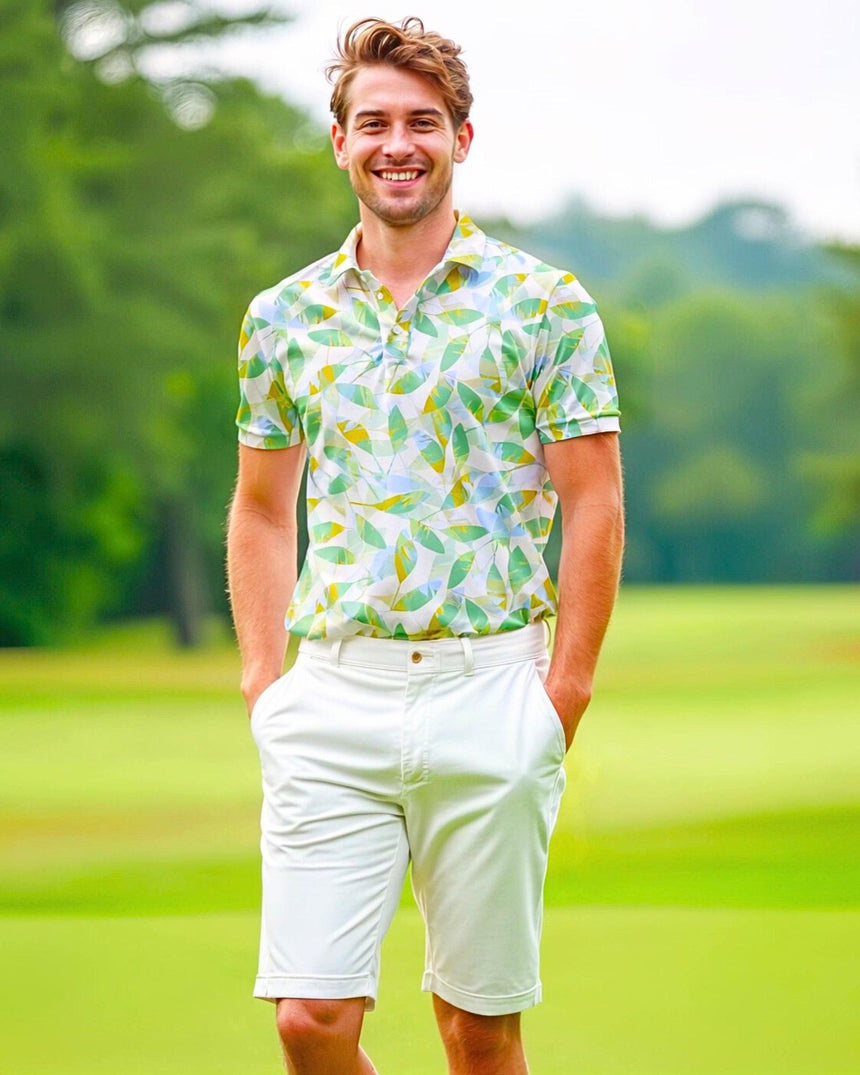 A man on a golf course wearing a colorful leaf print golf polo shirt