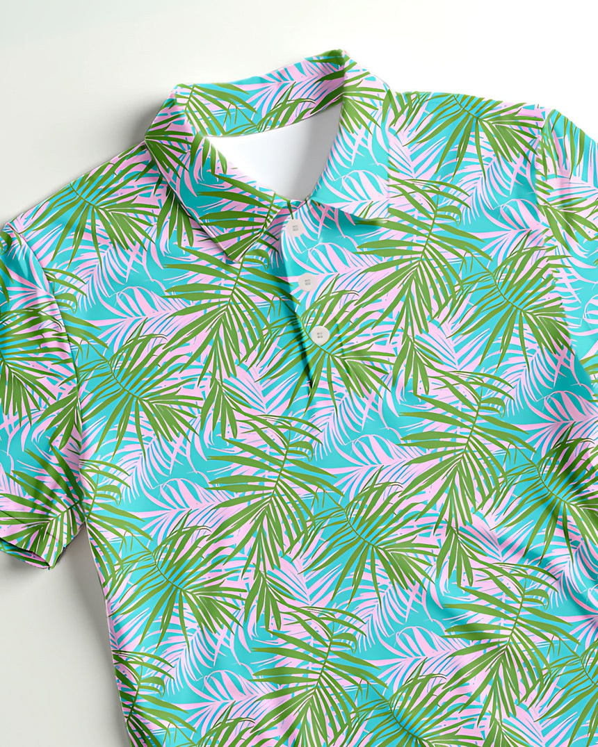 Close up of a short sleeve golf polo shirt with tropical leaf pattern
