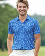 Man wearing a blue floral pattern polo shirt standing on a golf course