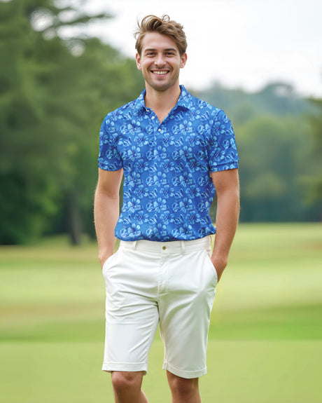 Man wearing a blue floral print golf polo and white shorts standing on a golf course.