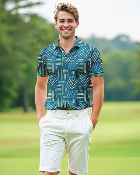 Man wearing a blue and green print golf polo shirt and white shorts standing on a golf course.