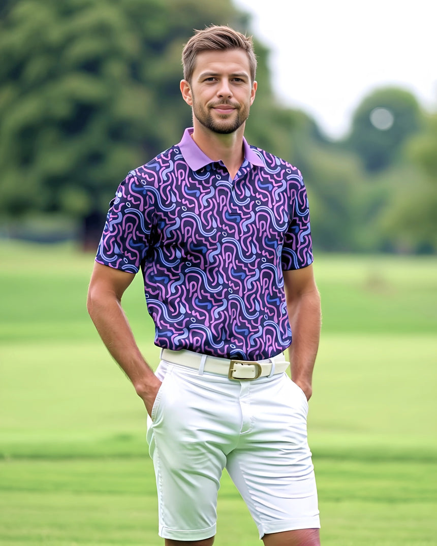 Man wearing a patterned purple shirt and white shorts on a golf course