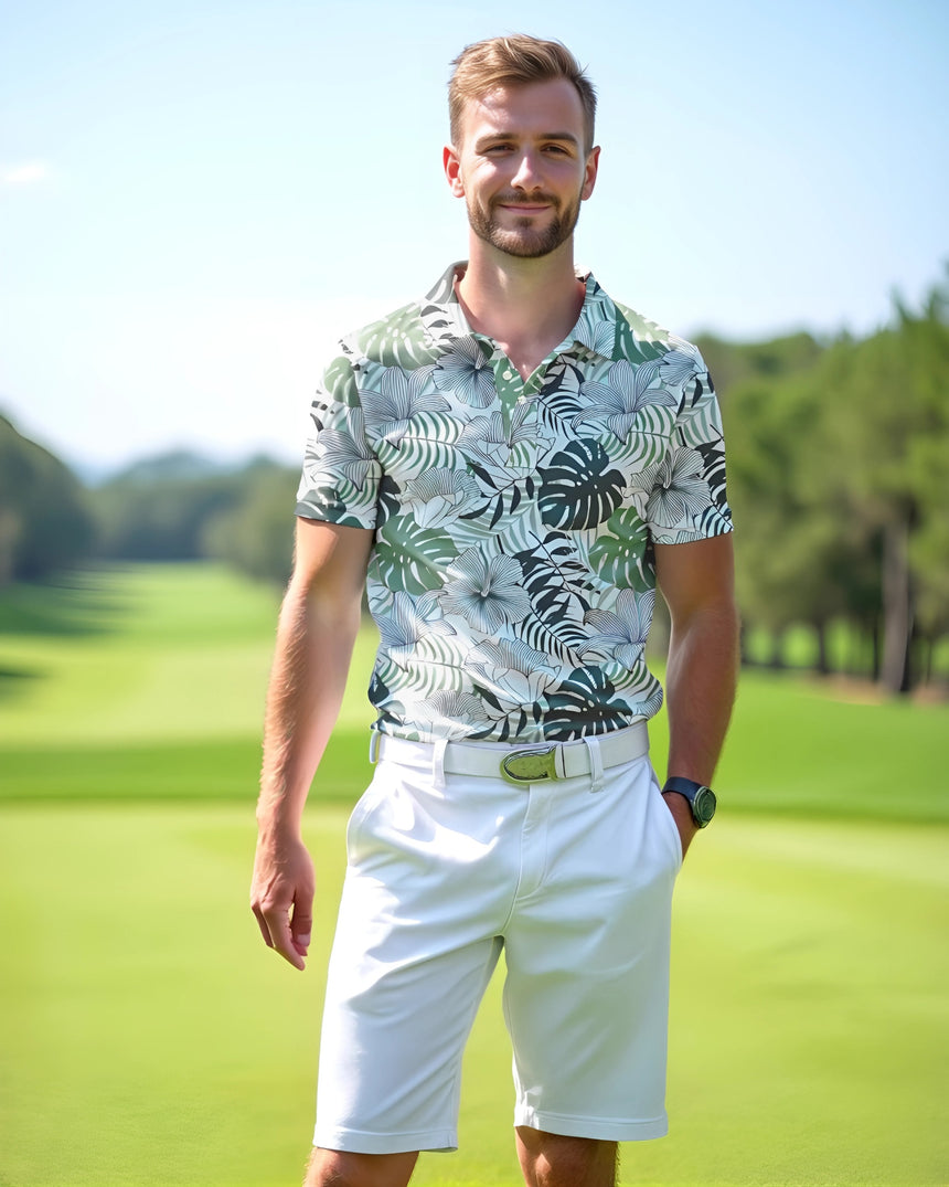 Man in a tropical golf polo and white shorts standing on a golf course