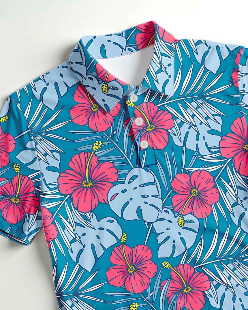 Close-up of a short sleeve golf polo shirt with pink and blue floral and leaf pattern