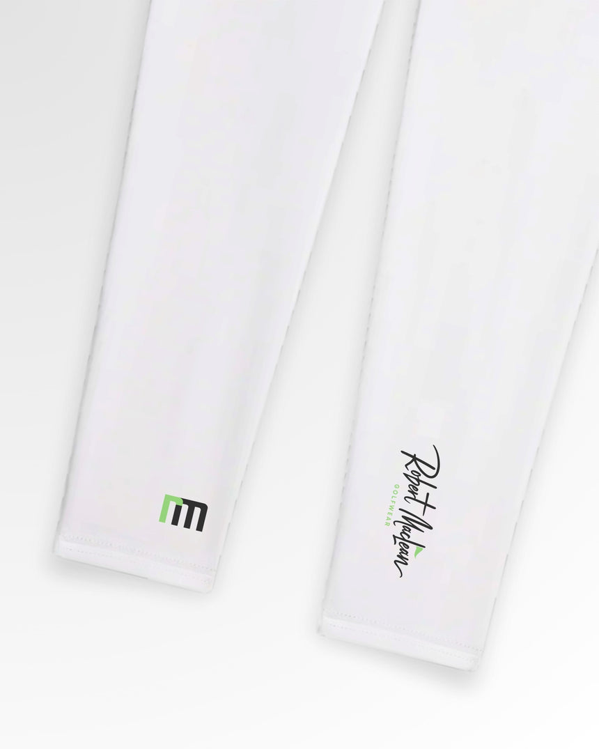 Close-up of two white Robert Maclean golf polos with the brand's logo on the right and a green and black geometric design on the left.