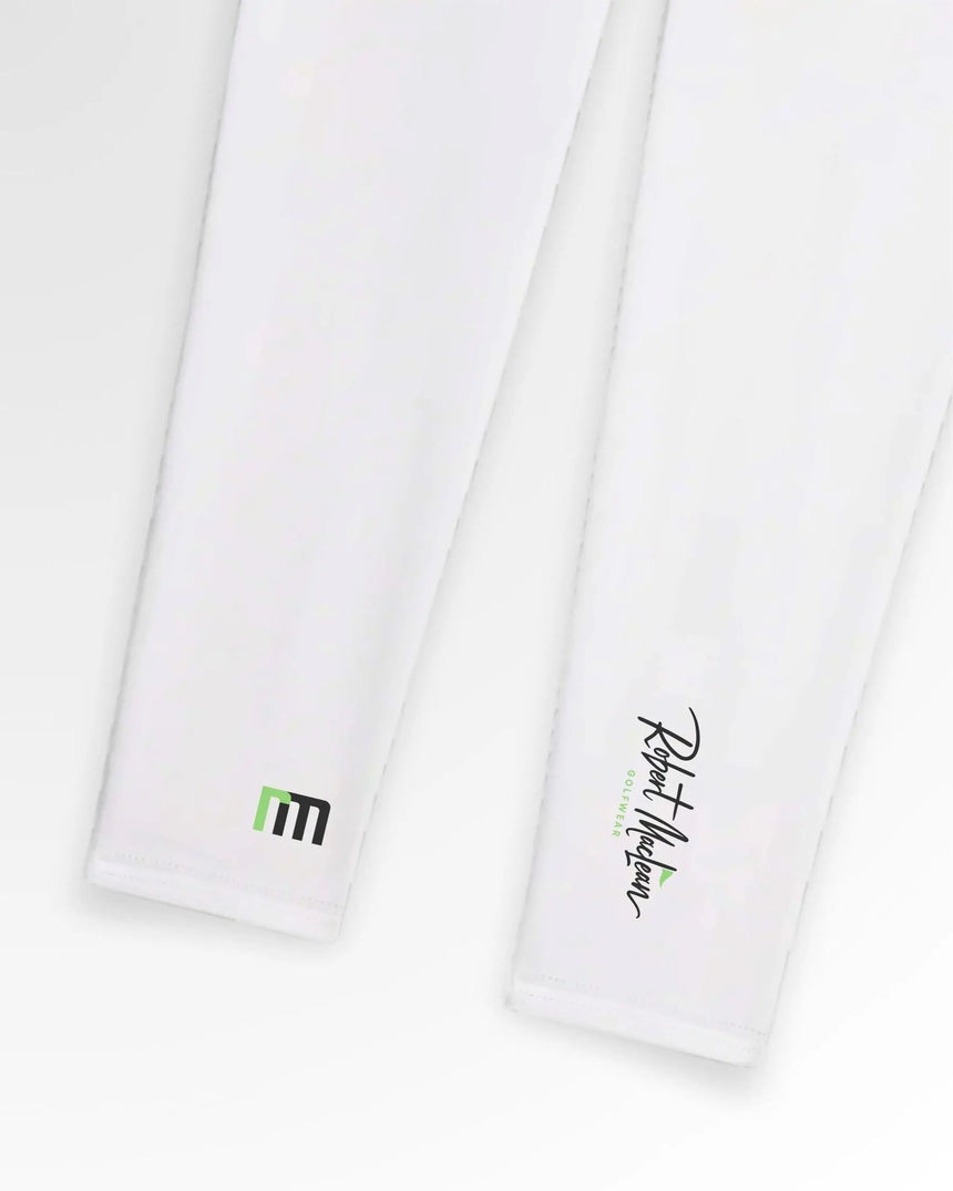 Close-up of two white Robert Maclean golf polos with the brand's logo on the right and a green and black geometric design on the left.