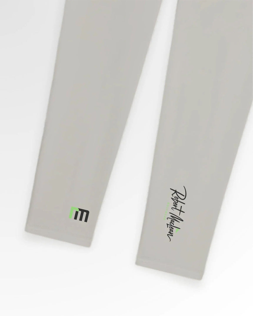 Close-up of Robert Maclean Golf Wear polo shirts in light gray, showcasing the brand's logo on one sleeve and the signature on the other.