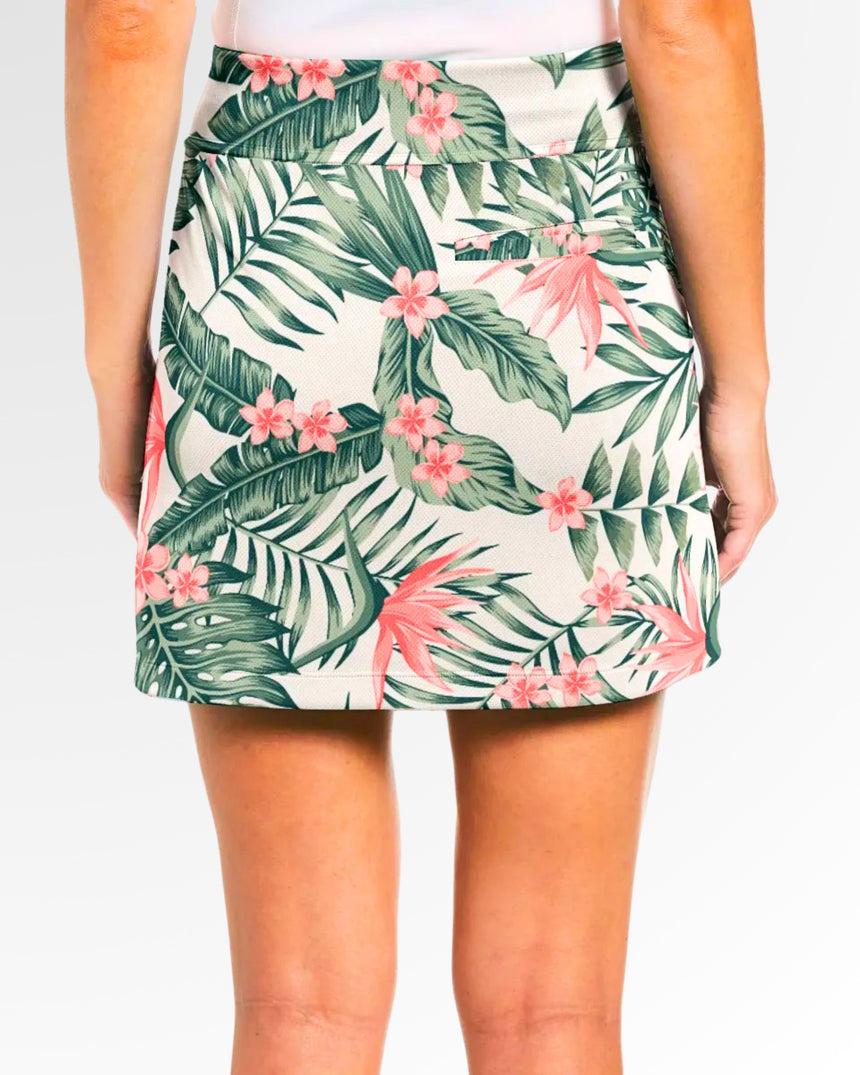 Back view of a woman wearing a golf skort with a tropical floral print.