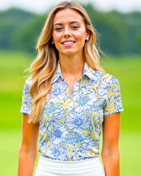 A woman smiles wearing a floral golf polo.