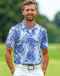 Man wearing a blue leaf-patterned golf polo shirt on a golf course