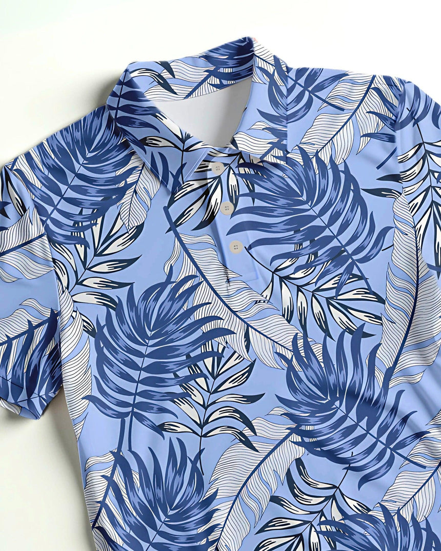 Close up of a blue tropical leaf-patterned golf polo shirt