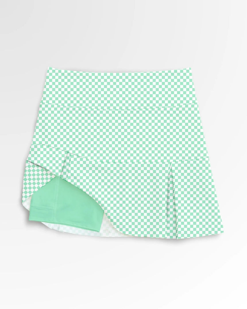 women's pleated golf skort with pockets in Checkered Greens print - front view