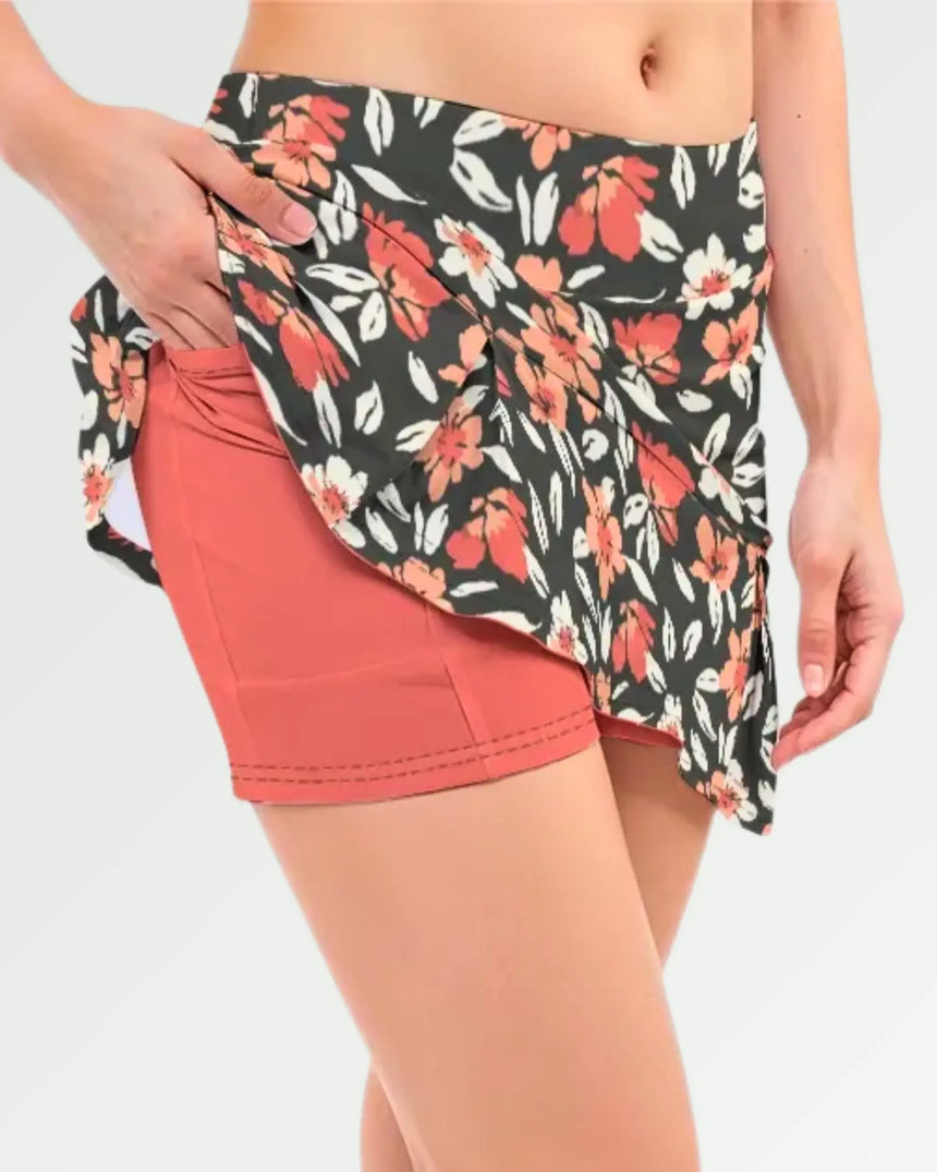 women's pleated golf skort with pockets in Coral Swing Floral print - fabric closeup front view