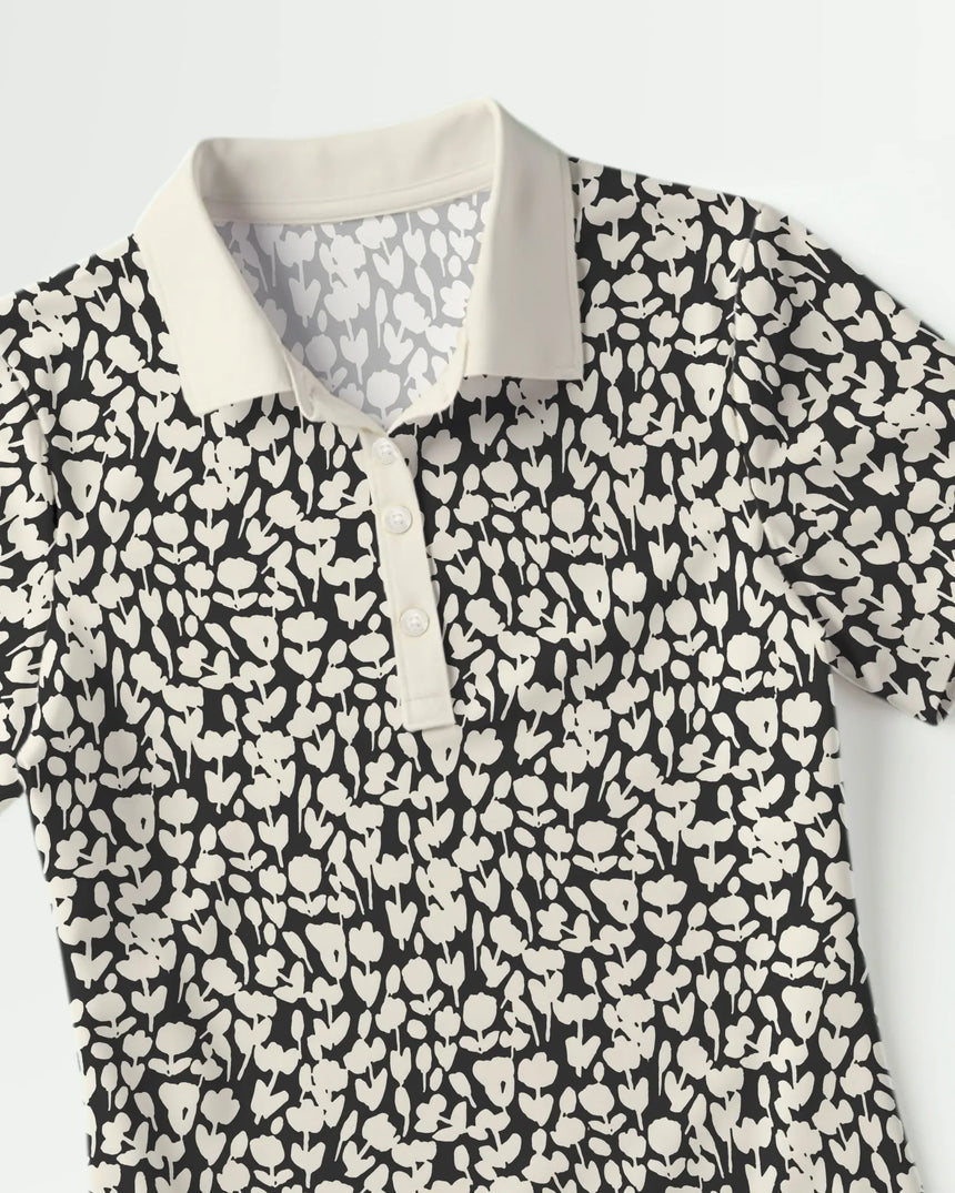 women's short sleeve golf polo in Midnight Meadow print - fabric closeup front view