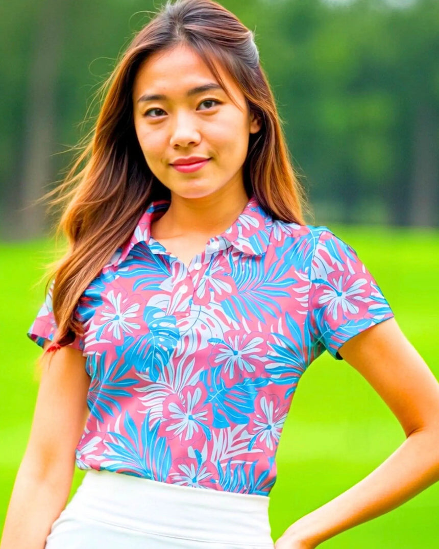 women's short sleeve golf polo in Pink Palms print - model wearing on course
