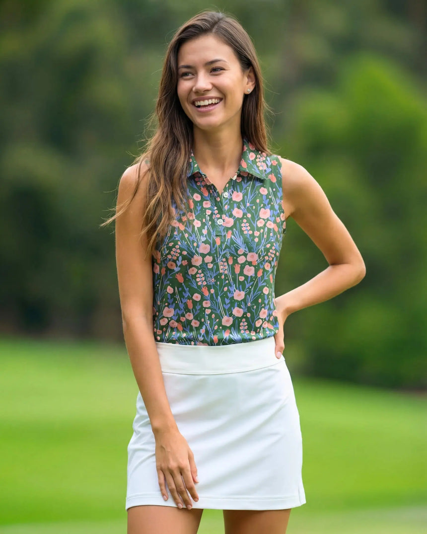 women's sleeveless golf polo in Back Nine Blossoms print - model wearing on course