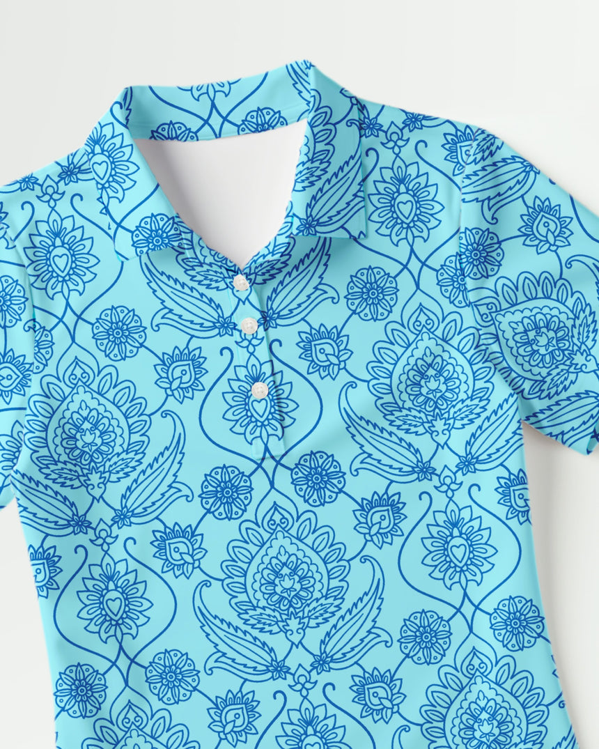 Blue patterned golf polo shirt with floral and abstract designs on a white background