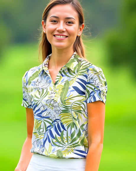 Woman wearing a tropical leaf patterned golf polo on a green outdoor background