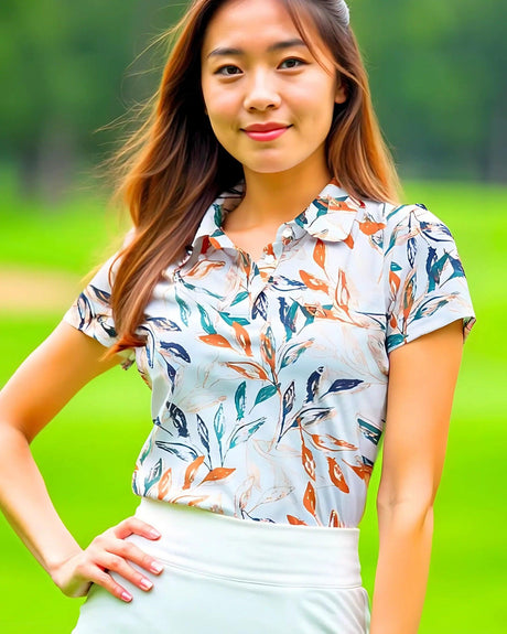 Woman wearing a floral polo shirt with a blurred green background