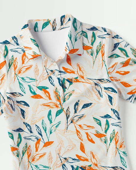 Short sleeve women's golf polo with colorful leaf pattern on a white background