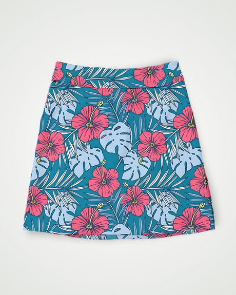 Teal and pink golf skort with tropical floral pattern on a white background