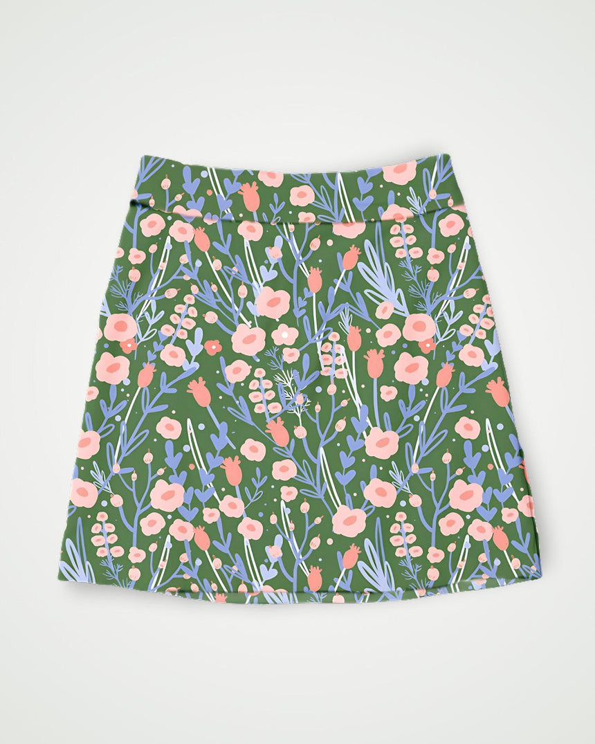 Green and pink ditsy floral pattern golf skort on a white background