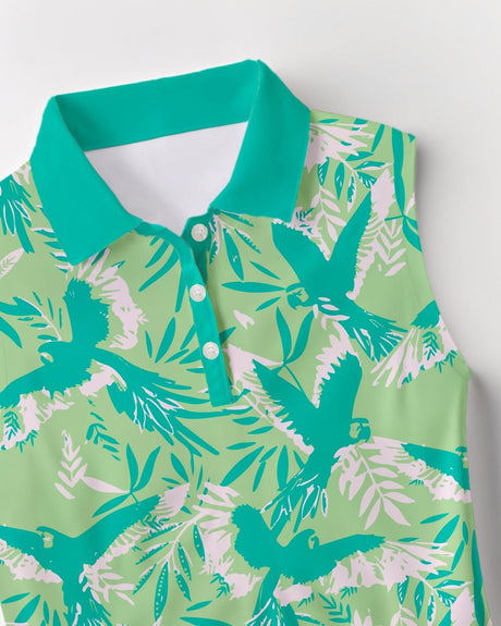Green and white tropical print sleeveless golf shirt with birds and leaves on a light gray background