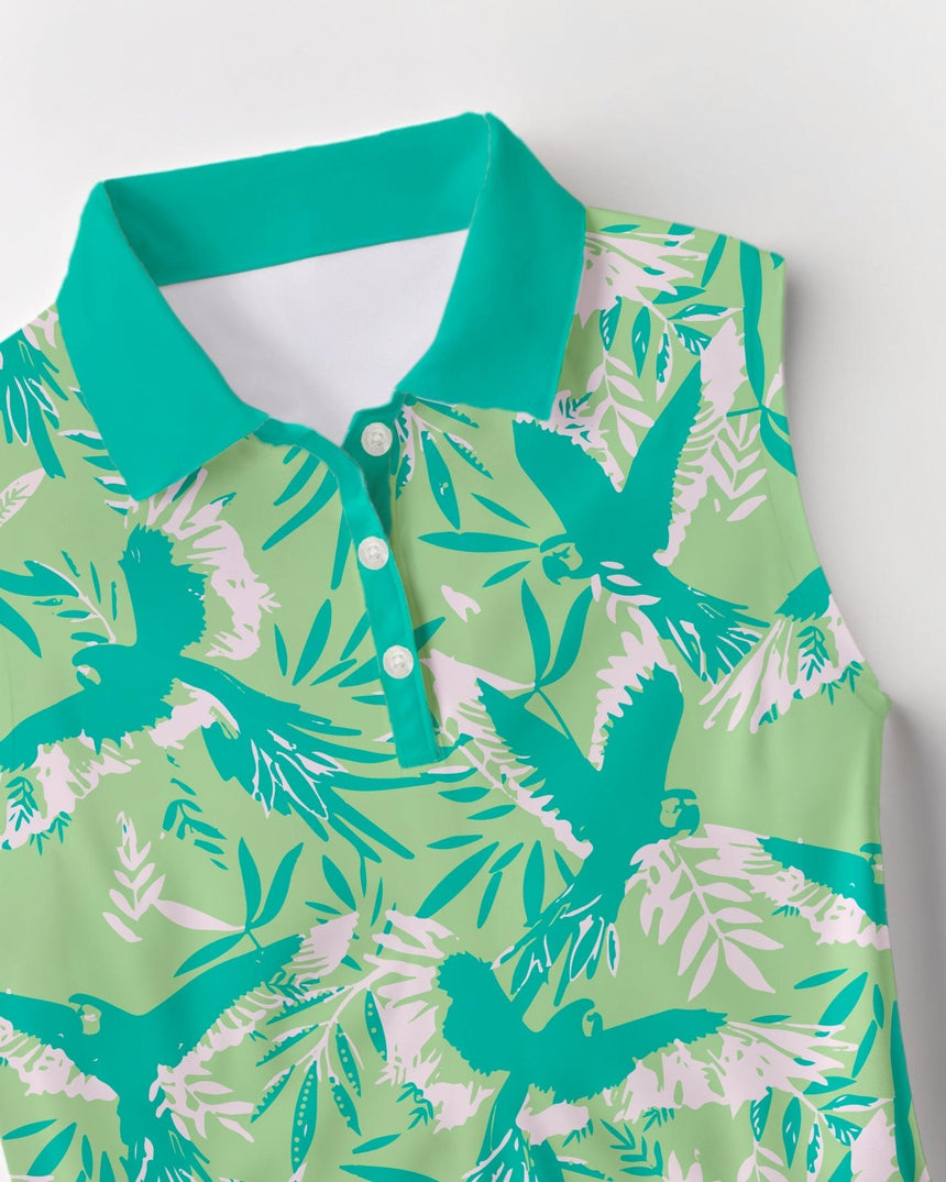 Green and white tropical print sleeveless golf shirt with birds and leaves on a light gray background