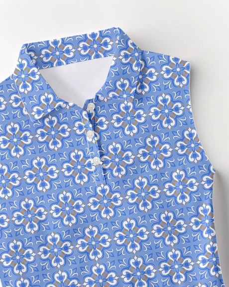 Blue floral tile print golf polo shirt on a light gray background