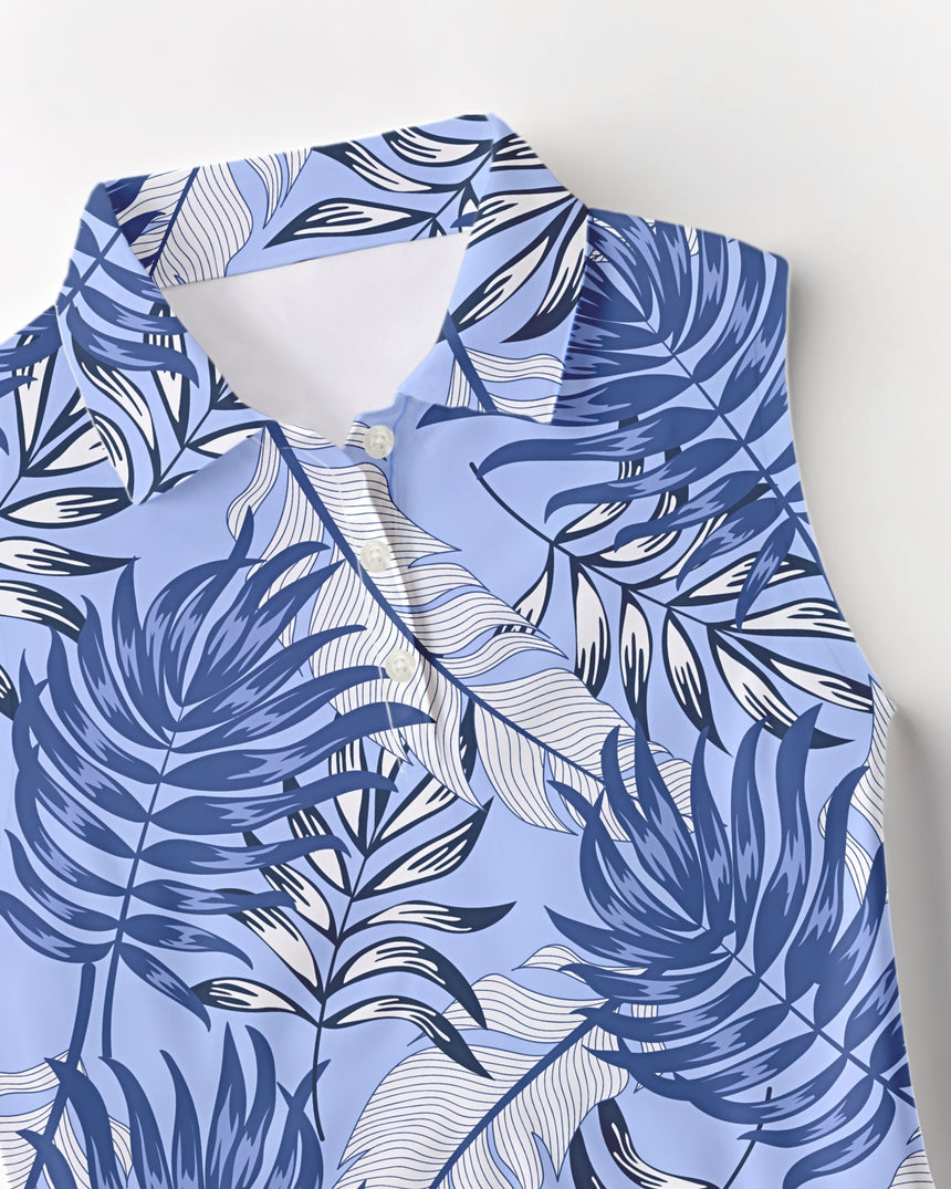 Blue and white tropical print polo shirt with palm leaf design on a light background