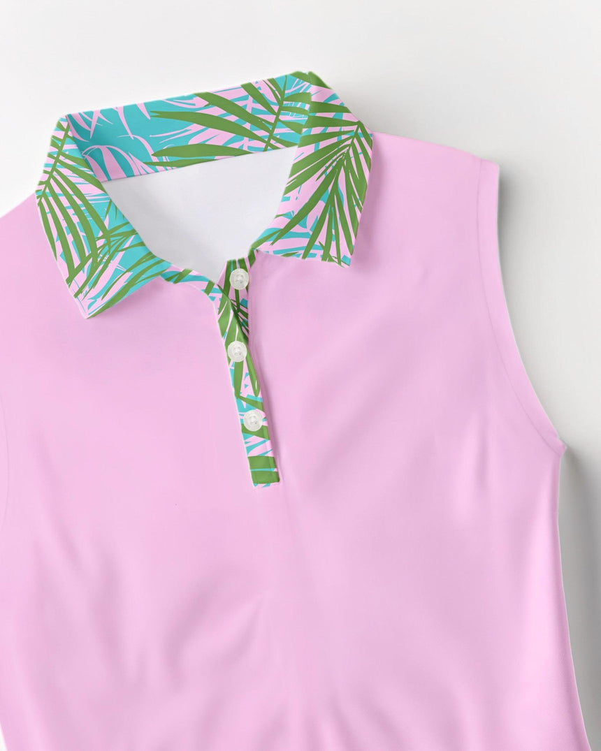 Pink sleeveless golf polo with a colorful palm leaf collar on a light gray background