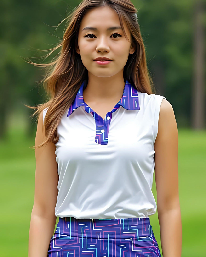 Woman wearing a white and blue patterned sleeveless top with a blurred green background