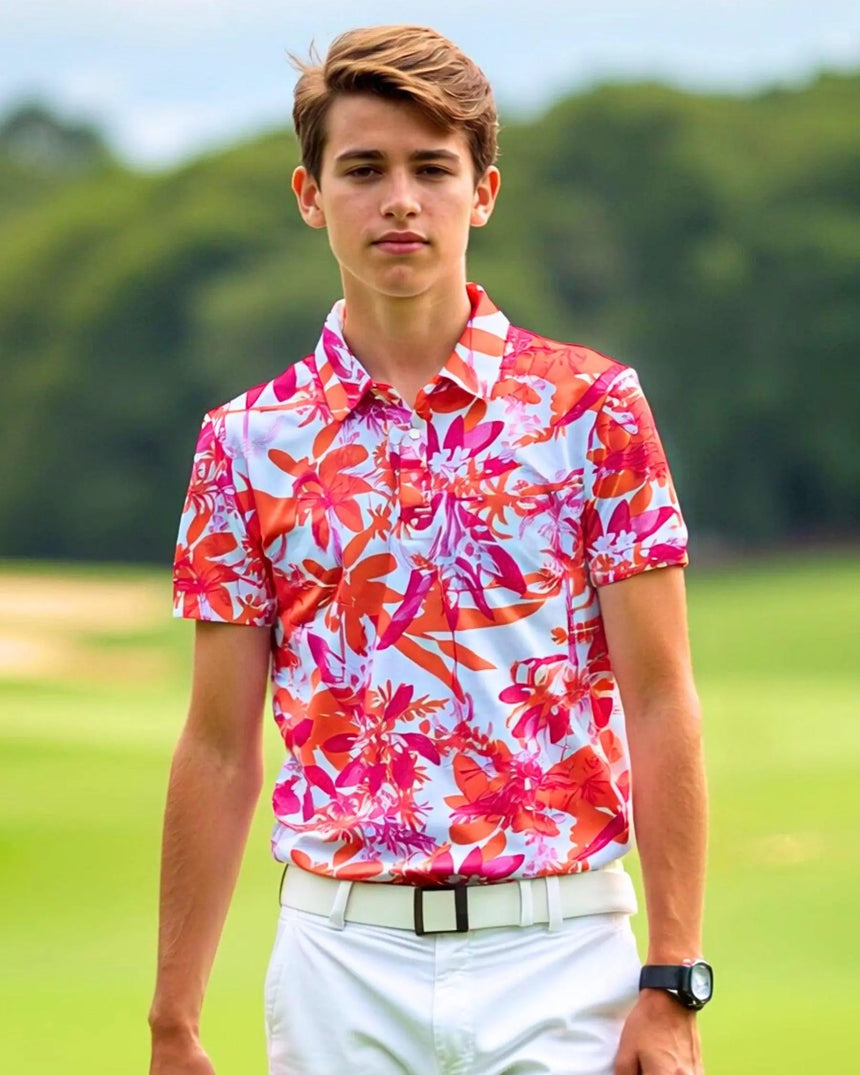 youth short sleeve golf polo in Hot Tropic print - model wearing on course