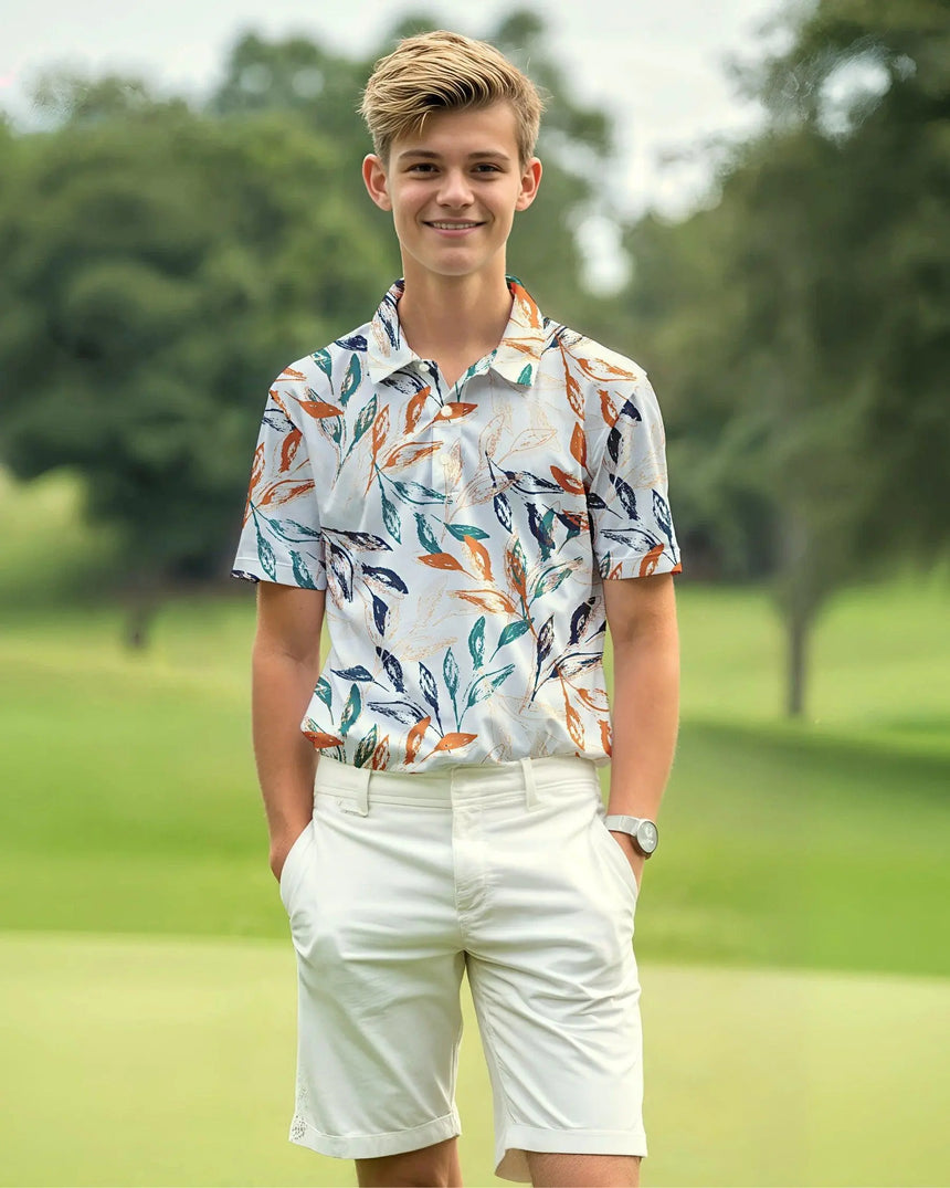 youth short sleeve golf polo in Leaf It On the Green print - model wearing on course