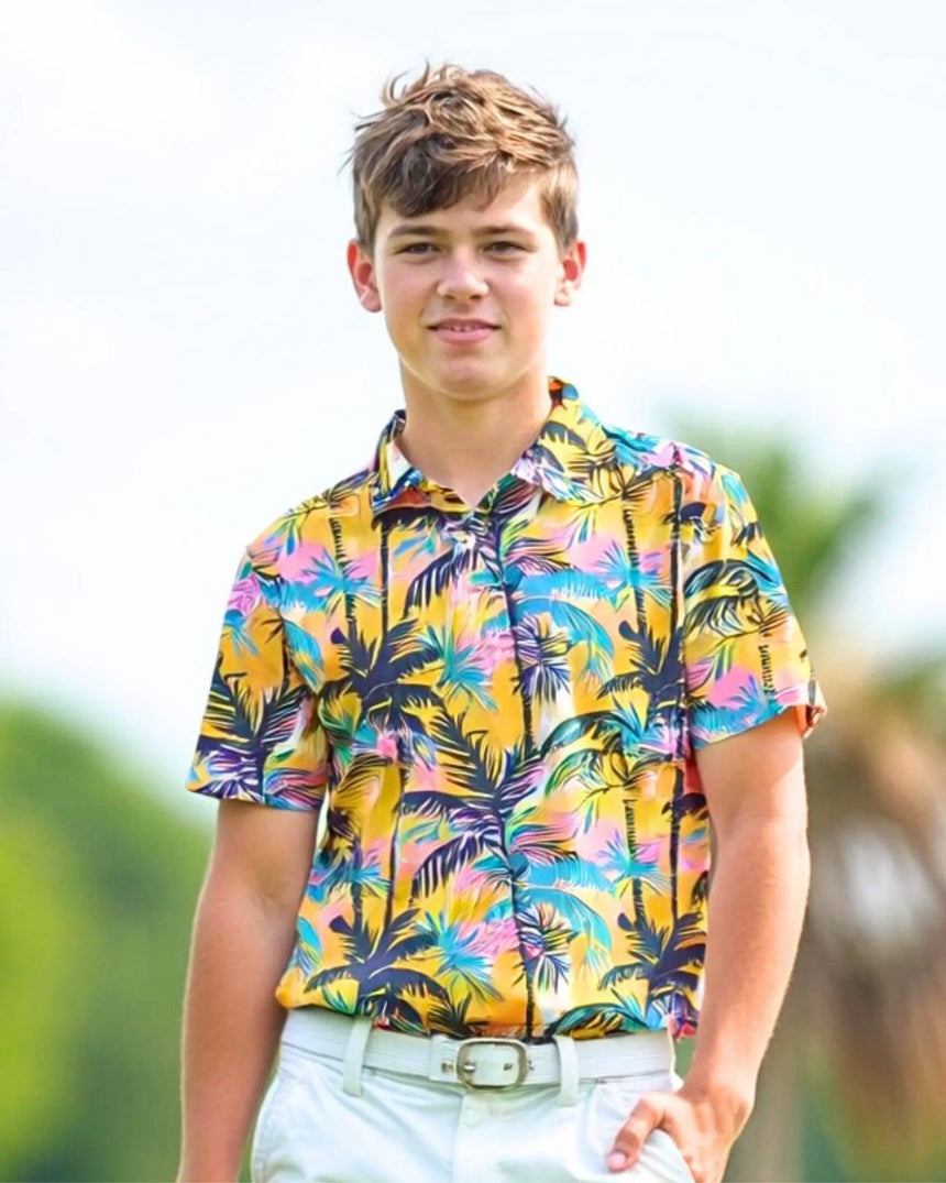 youth short sleeve golf polo in The Palms print - model wearing on course