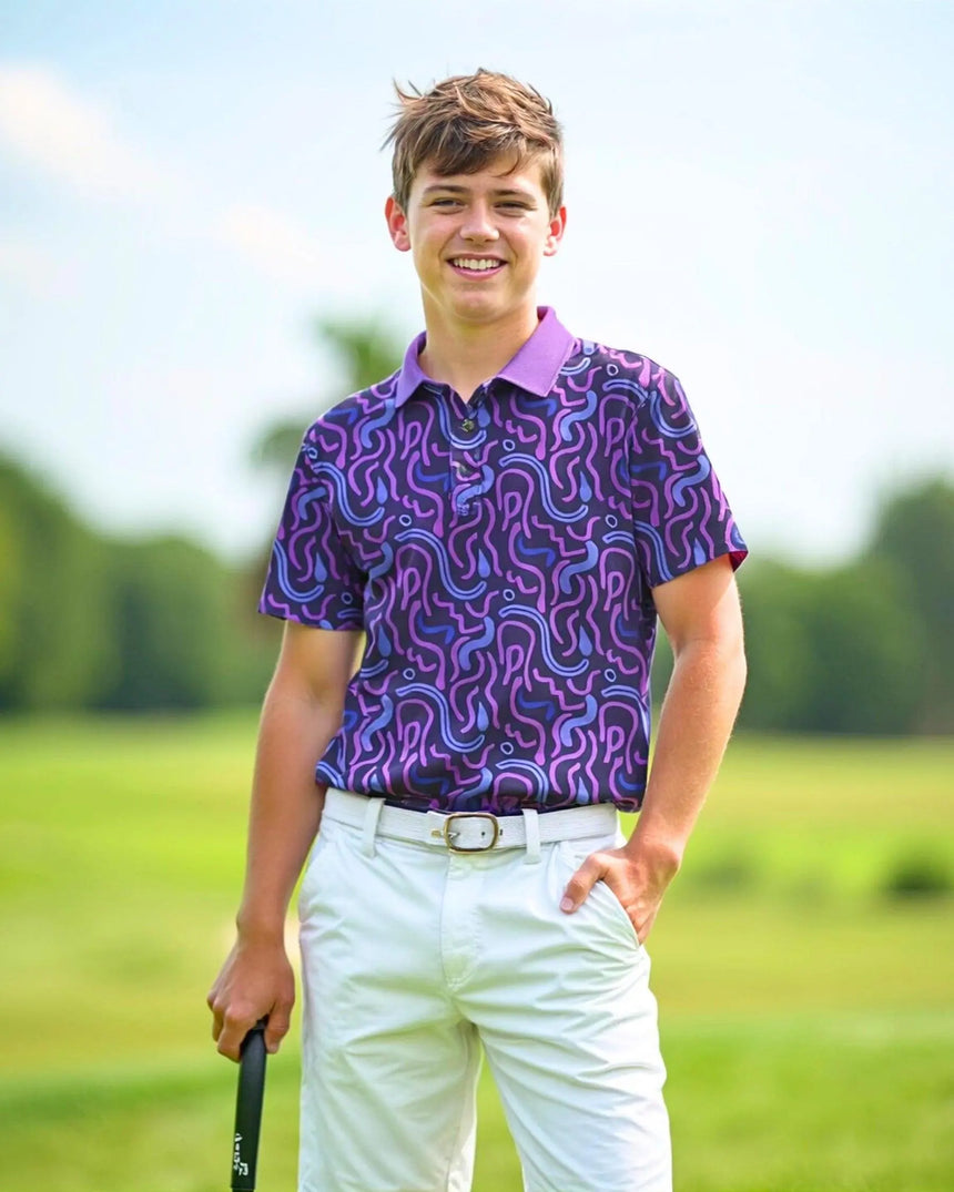 youth short sleeve golf polo in Wild Tee Party print - model wearing on course