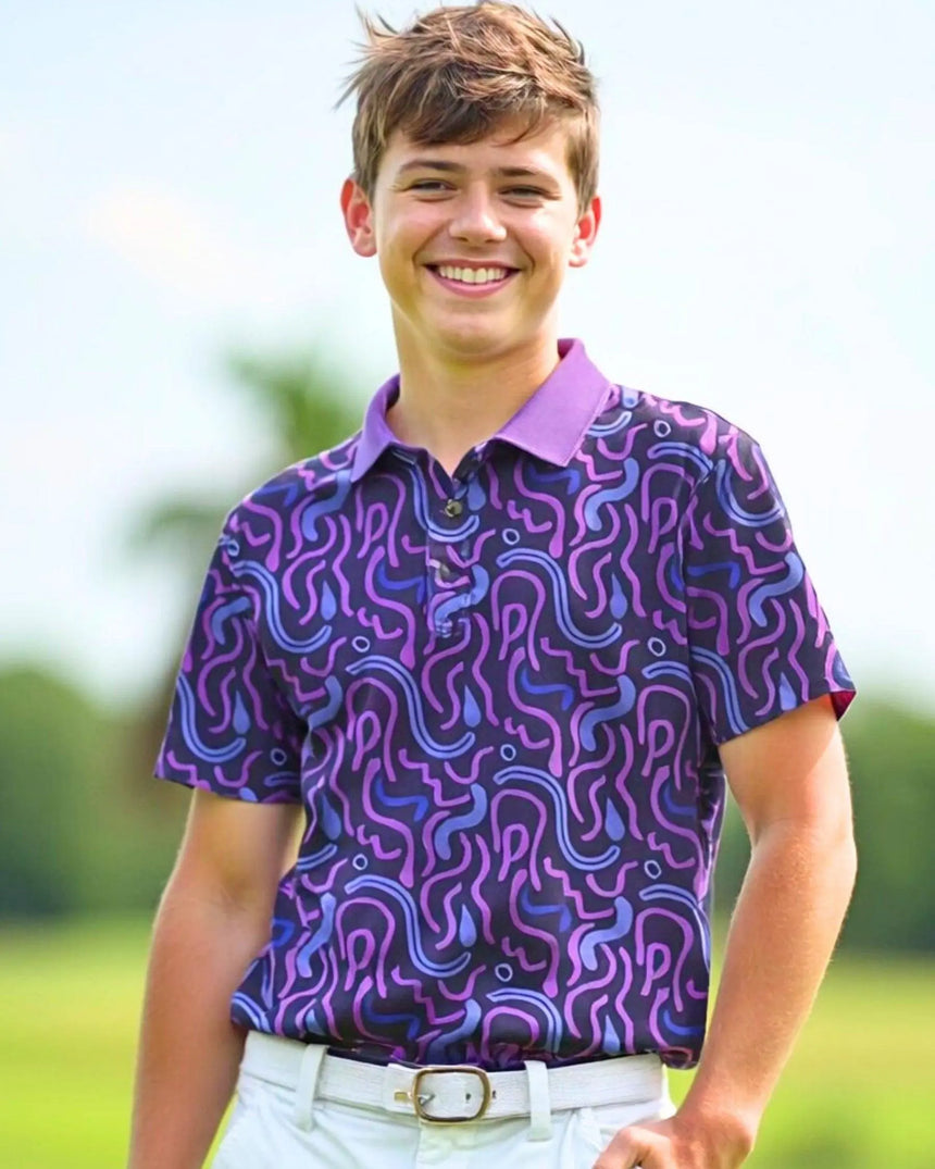 youth short sleeve golf polo in Wild Tee Party print - model wearing on course