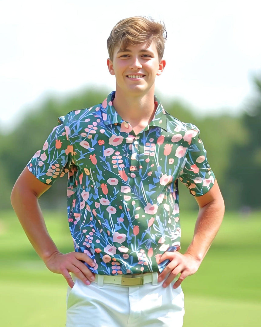 Teenage boy wearing a colorful floral polo shirt on a blurred green background