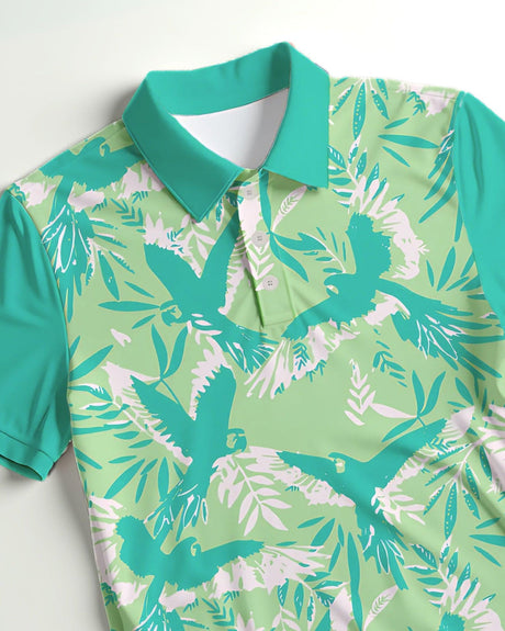 Green polo shirt with bird and leaf pattern on a white background