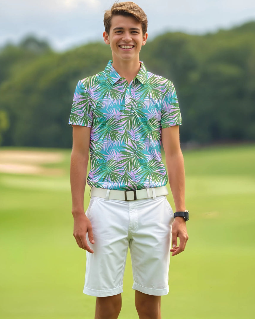 Teenager wearing a colorful patterned polo shirt and white shorts on a golf course