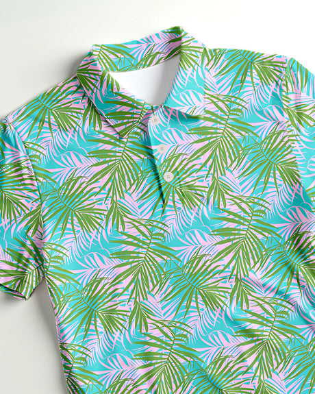 Colorful tropical leaf pattern polo shirt on a white background