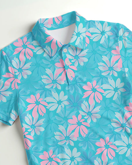Blue and pink floral patterned golf shirt on a white background