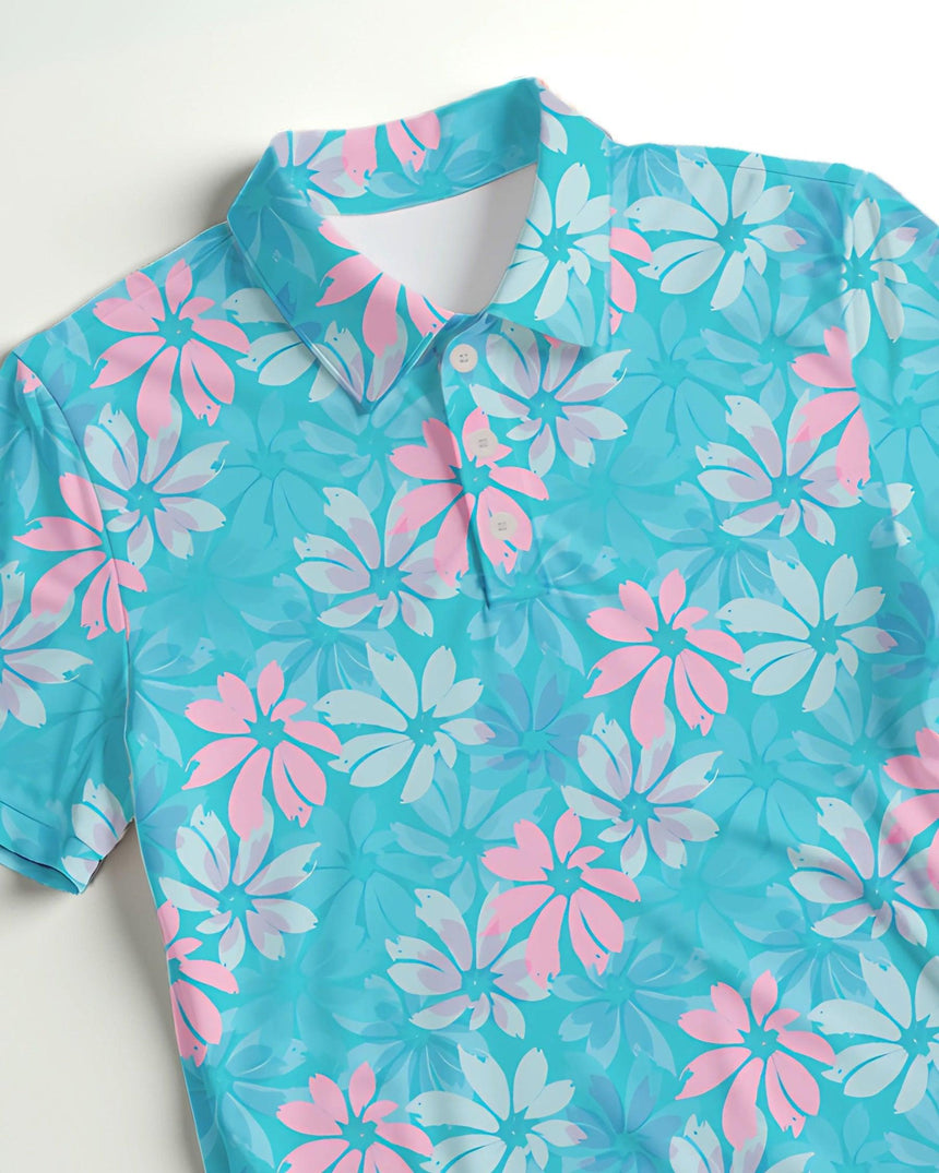 Blue and pink floral patterned golf shirt on a white background