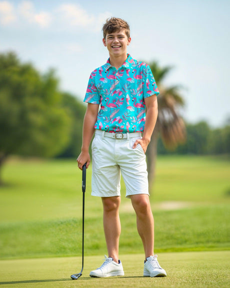 Person on a golf course wearing a colorful shirt and white shorts, holding a golf club.