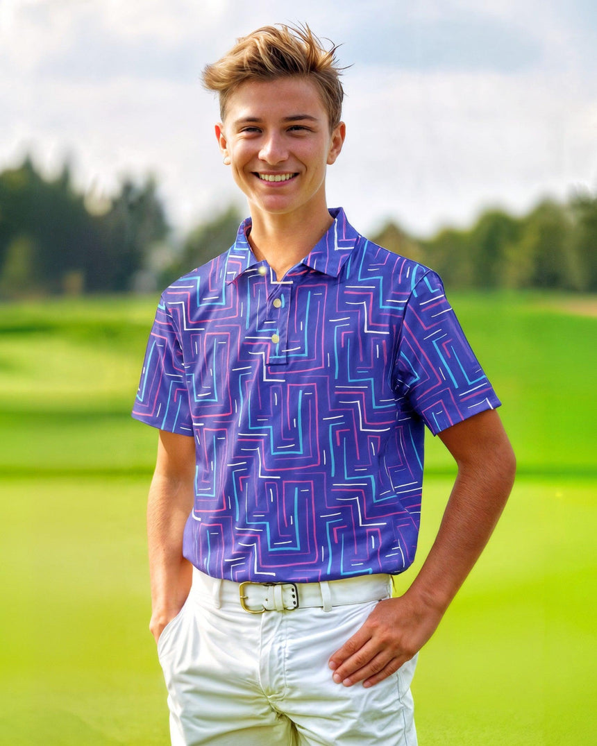 Young boy wearing a purple patterned polo shirt on a golf course