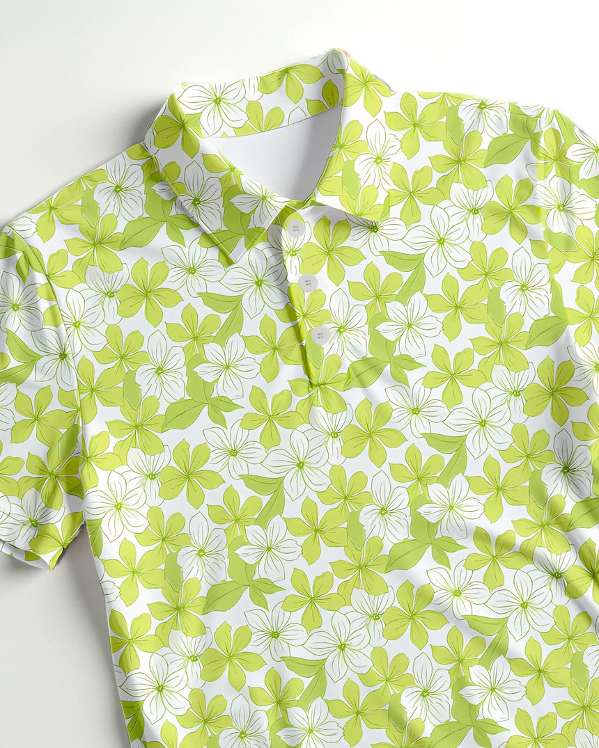 Green and white floral print golf polo on a light gray background