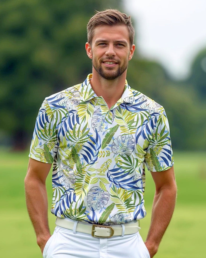 A smiling man in a tropical print golf polo shirt stands on a golf course.