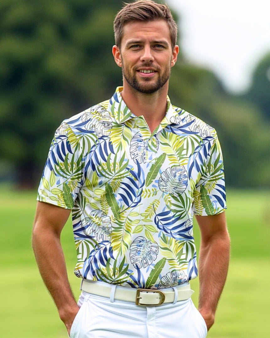 Man in a golf polo with a tropical leaf pattern, white pants, and a white belt.