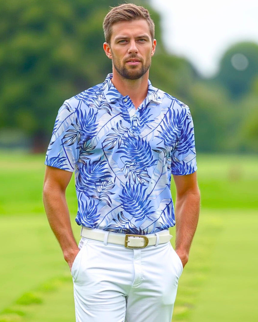 A man on a golf course wearing a blue tropical print golf polo shirt